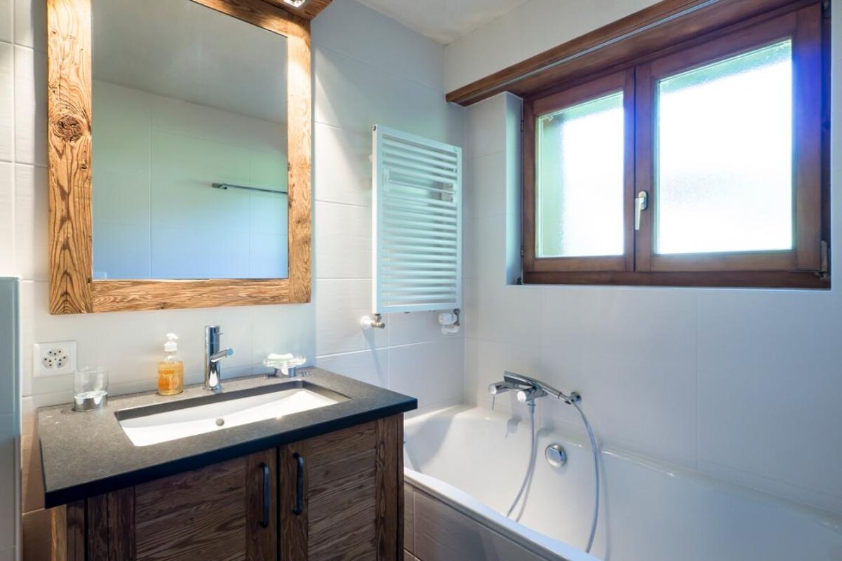 A bathroom with a sink and a window