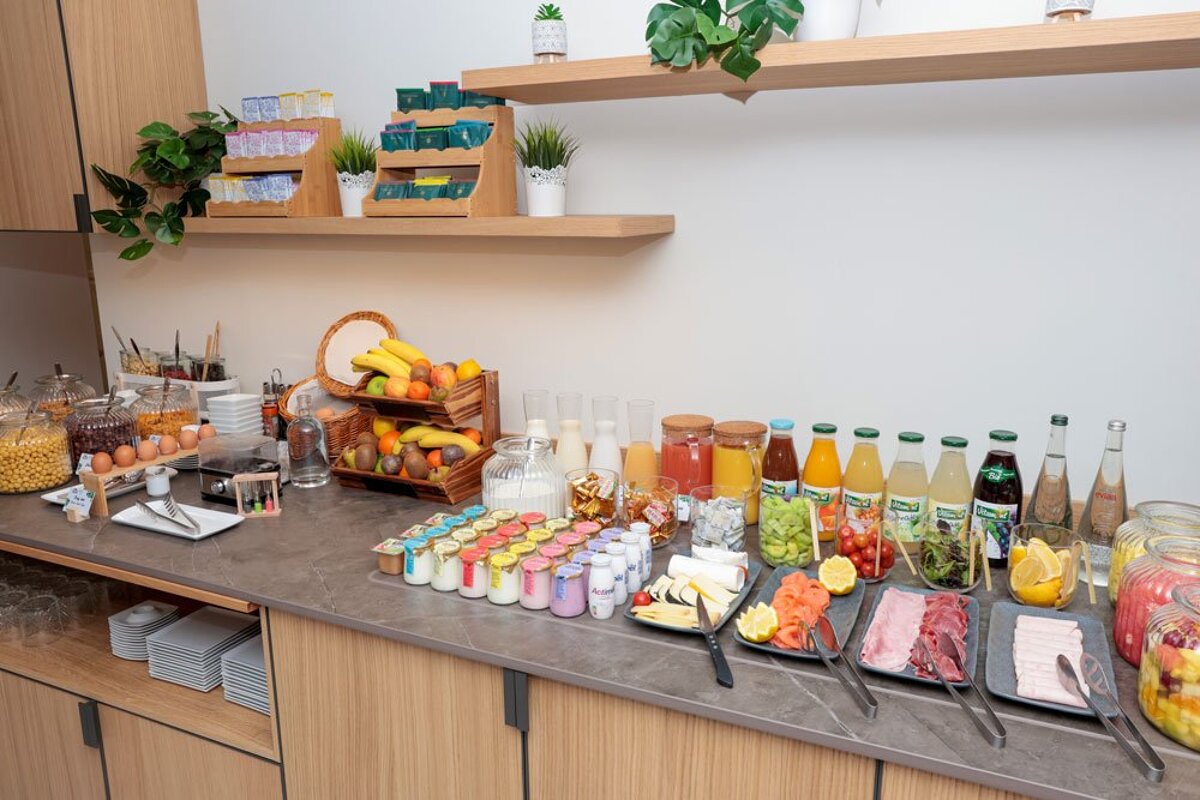 A buffet with a variety of food and drinks including a bottle of tropicana