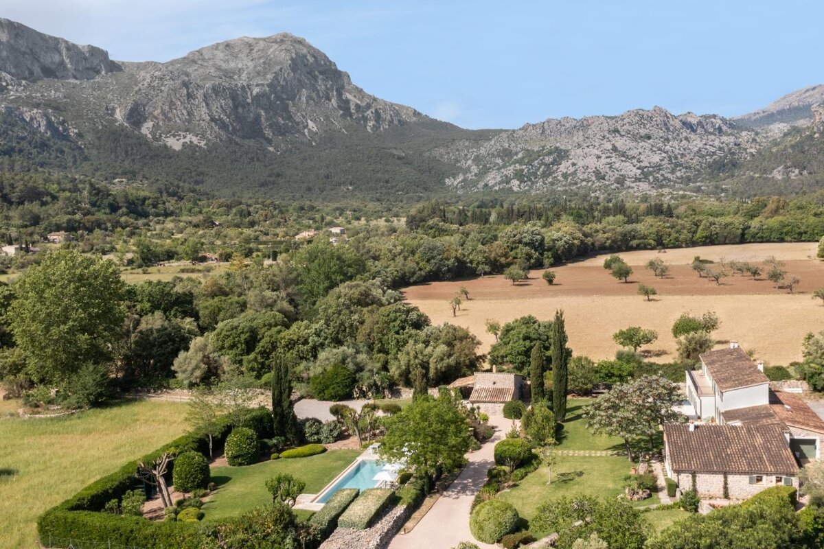 An aerial view of a house with mountains in the background