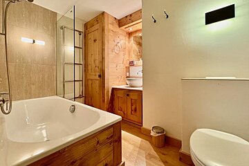 A bathroom with a bathtub a sink and a toilet