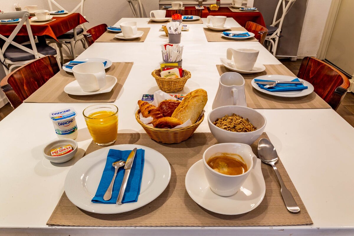 A table with a variety of food on it including a bottle of daybreak
