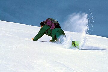 a skier stopping himself from falling