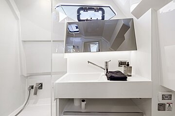 A white bathroom with a sink and a mirror