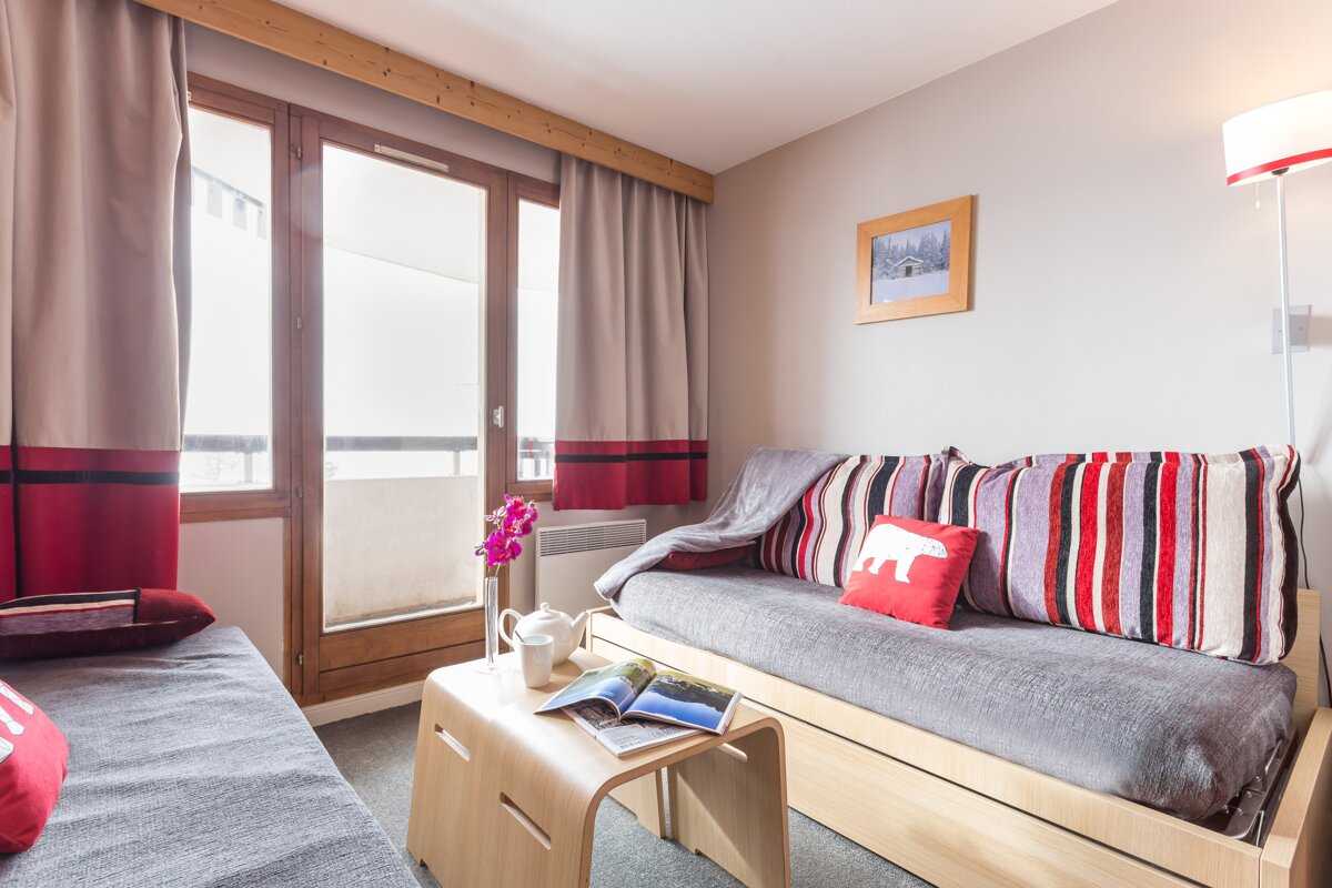 A living room with a couch and a table with a book on it