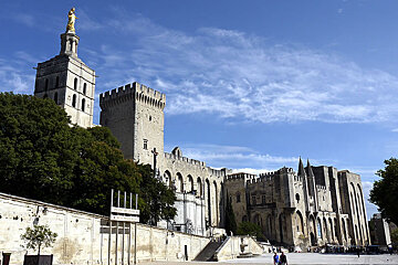 A large castle with a statue on top of it