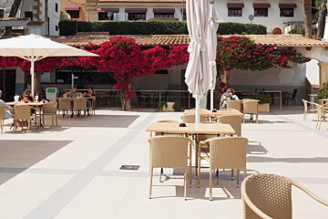 a terrace with cream wicker chairs