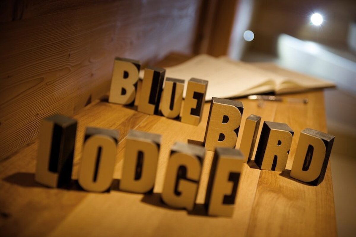 A wooden table with the words blue bird lodge on it
