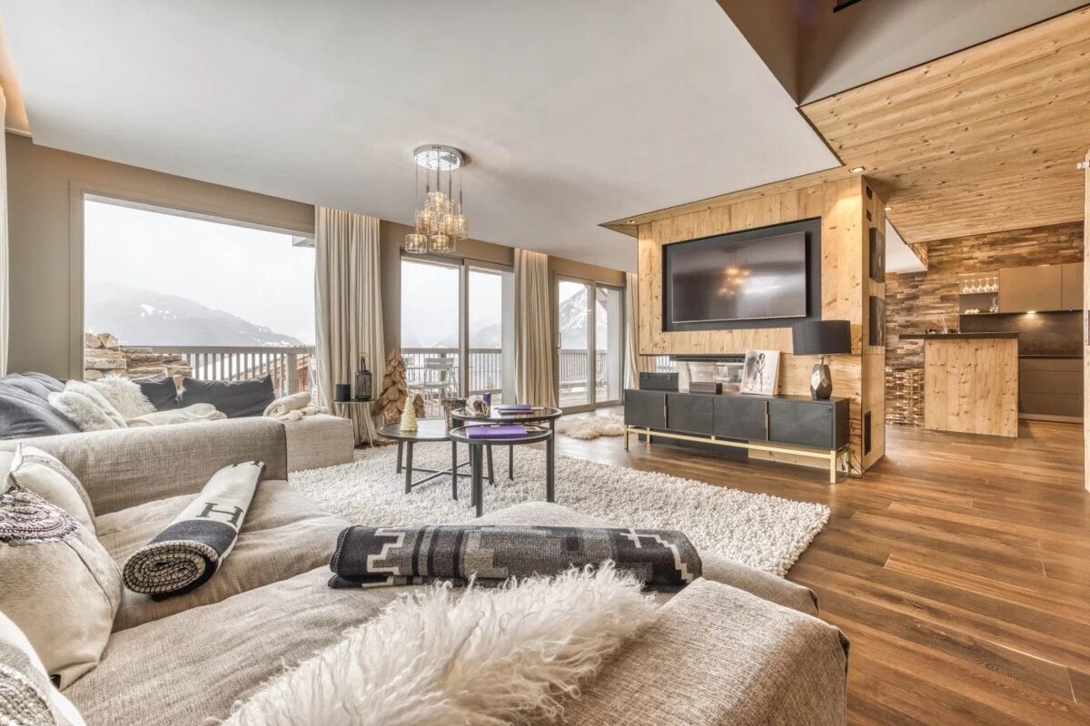 A living room with a large flat screen tv on the wall