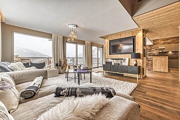 A living room with a large flat screen tv on the wall