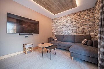 A living room with a couch and a flat screen tv