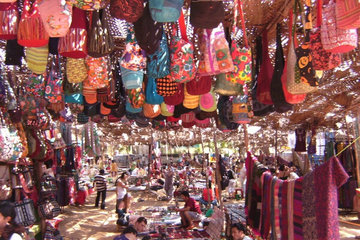 lots of coloured fabircs, bags & hippy garments hanging up