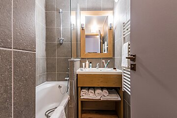 A bathroom with a sink a mirror and a bathtub