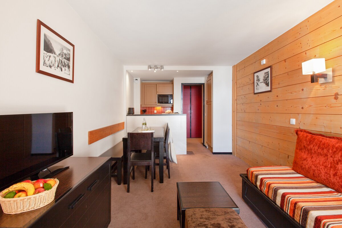 A living room with a couch a table and a television