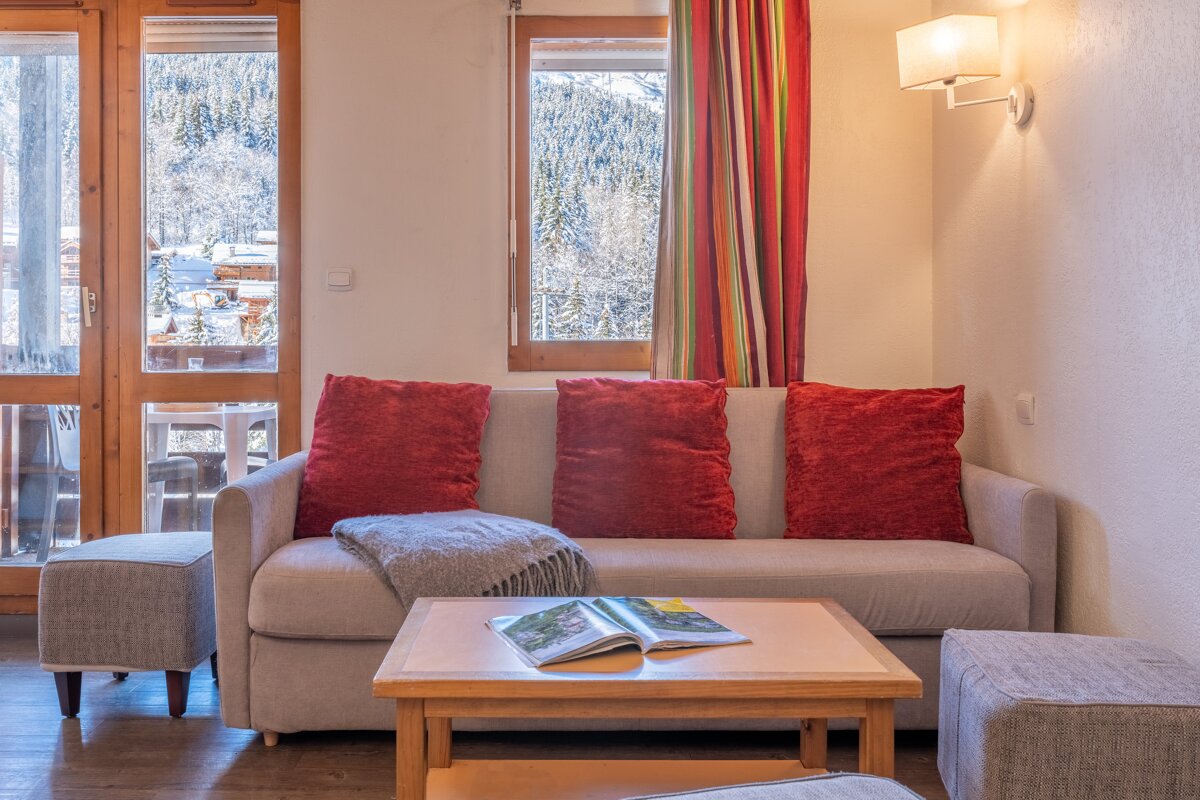 A living room with a couch and a table with a book on it