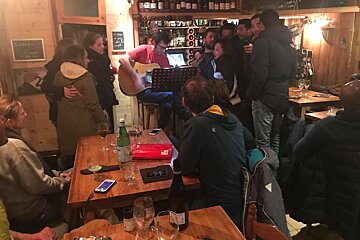 A man singing into a microphone in a restaurant