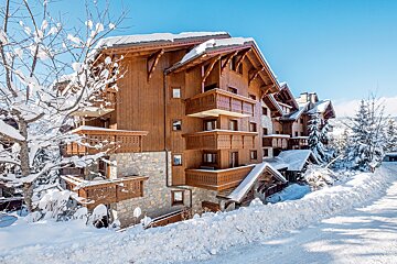 A snow covered building with a blue sky in the background
