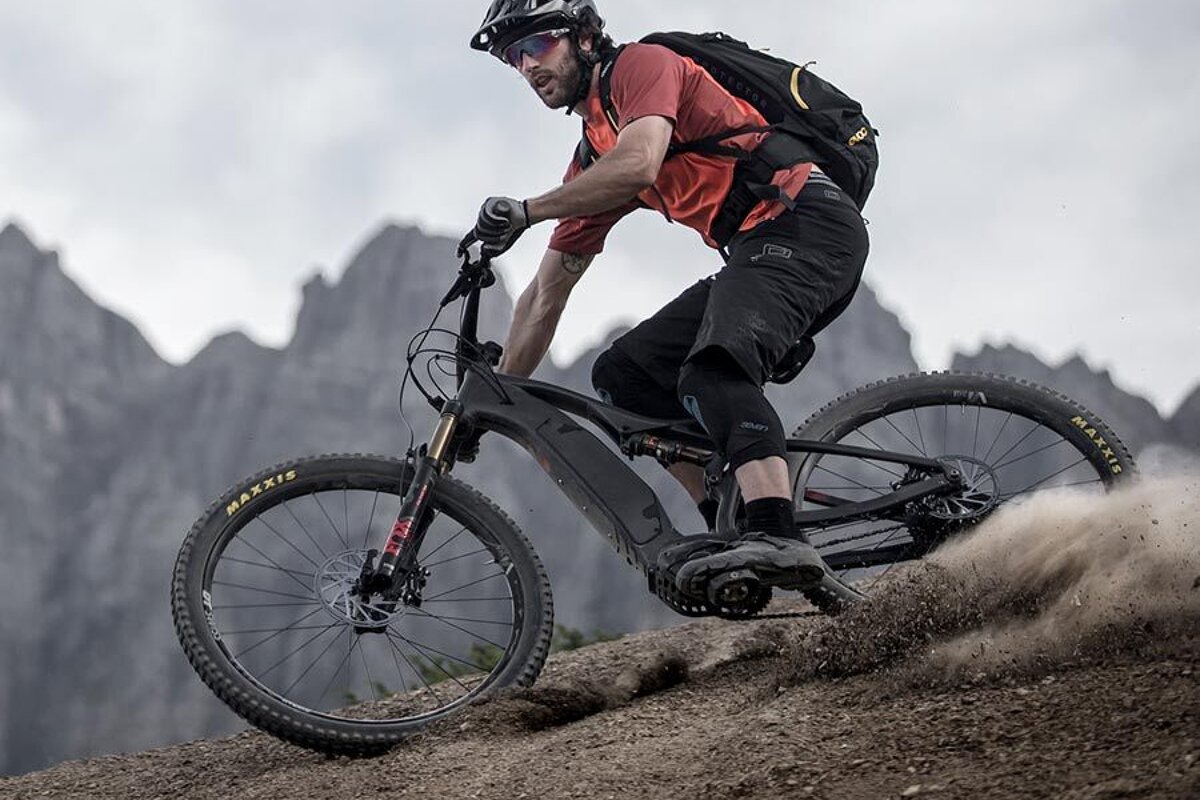 A man is riding a bike with maxxis tires