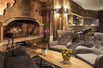 A living room with a fireplace and a table with fruit on it