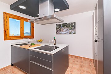 A kitchen with a picture of a river on the wall