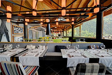 A restaurant with a lot of tables and chairs
