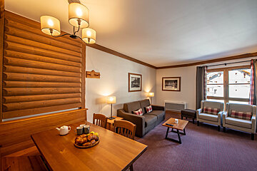 A living room with a couch and two chairs