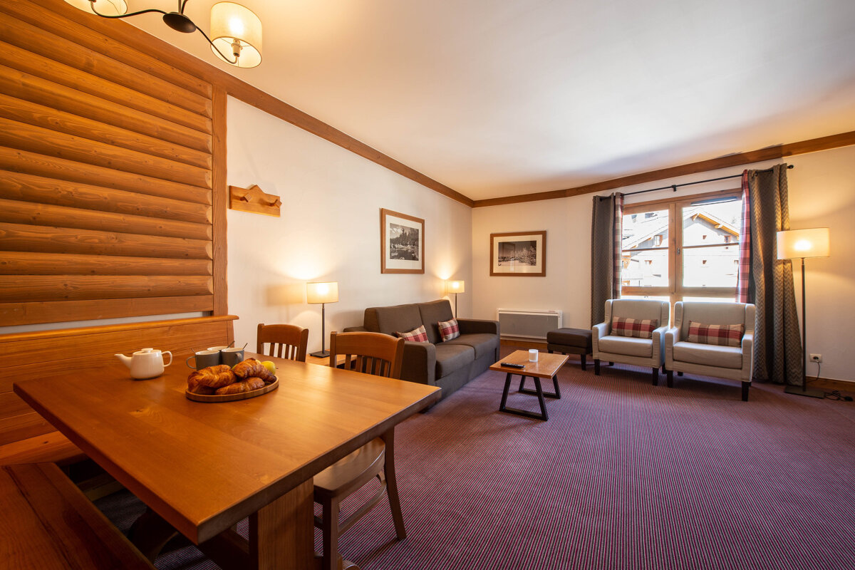 A living room with a table and chairs and a couch