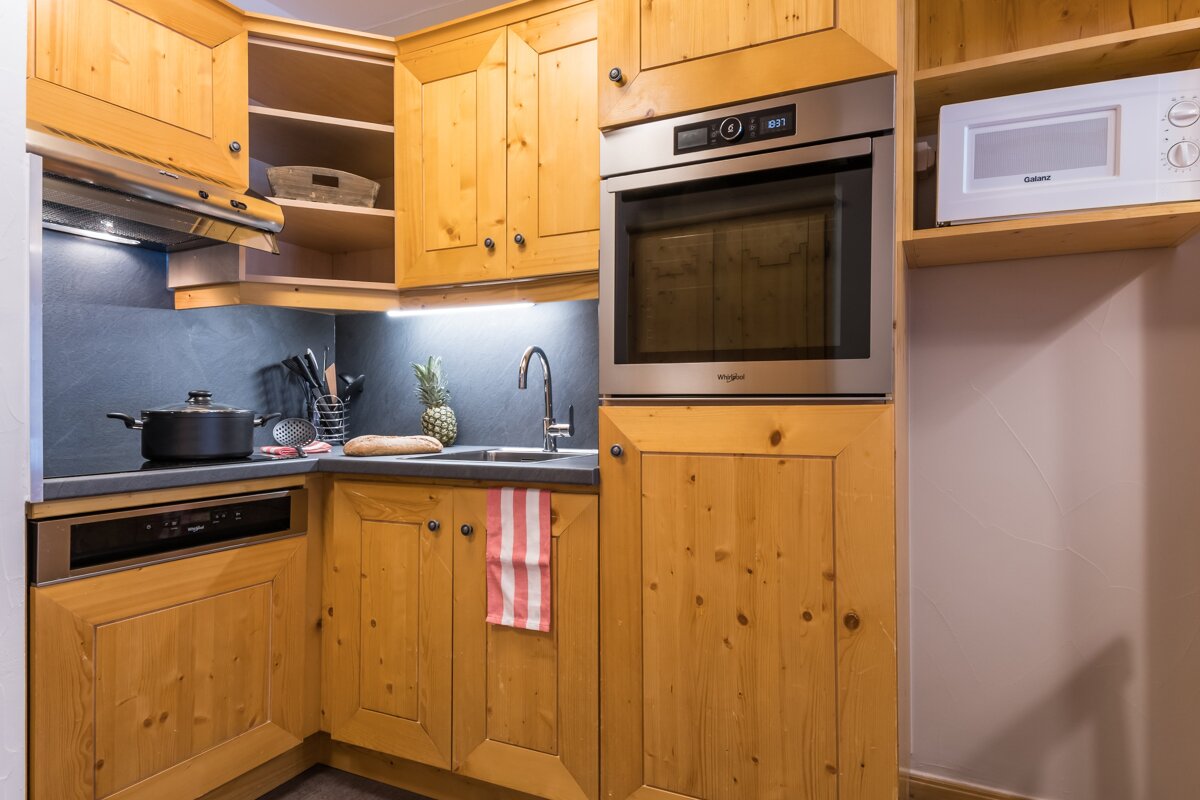 A kitchen with wooden cabinets and a whirlpool oven