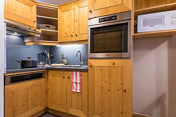 A kitchen with wooden cabinets and a whirlpool oven