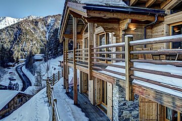 A large wooden building with a snowy mountain in the background