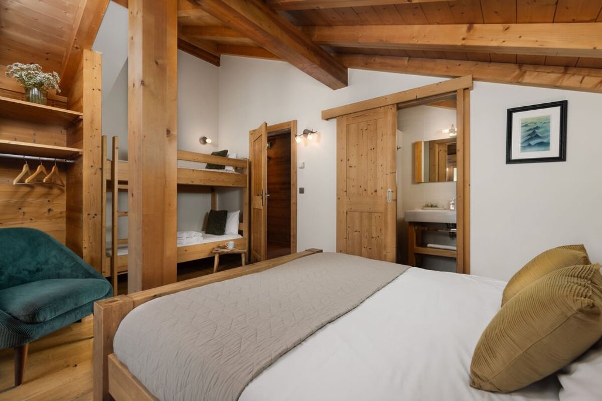 A bedroom with a bunk bed and a picture on the wall