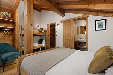 A bedroom with a bunk bed and a picture on the wall