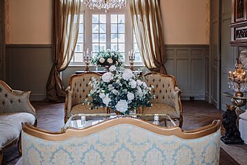 A vase of flowers sits on a table in a living room