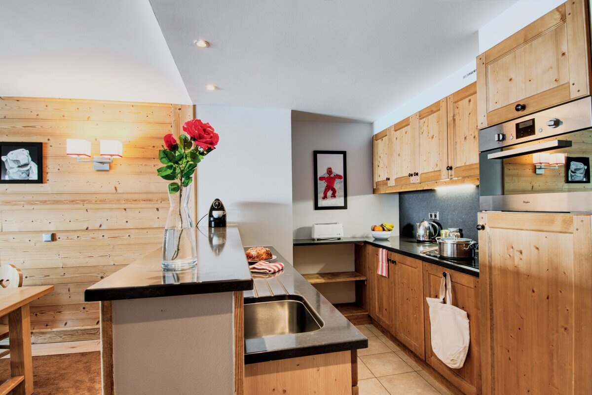 A kitchen with a picture of a gingerbread man on the wall
