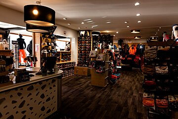 A store with a sign that says ' altitude ' on it