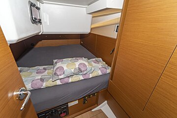 A bed with a polka dot blanket on it