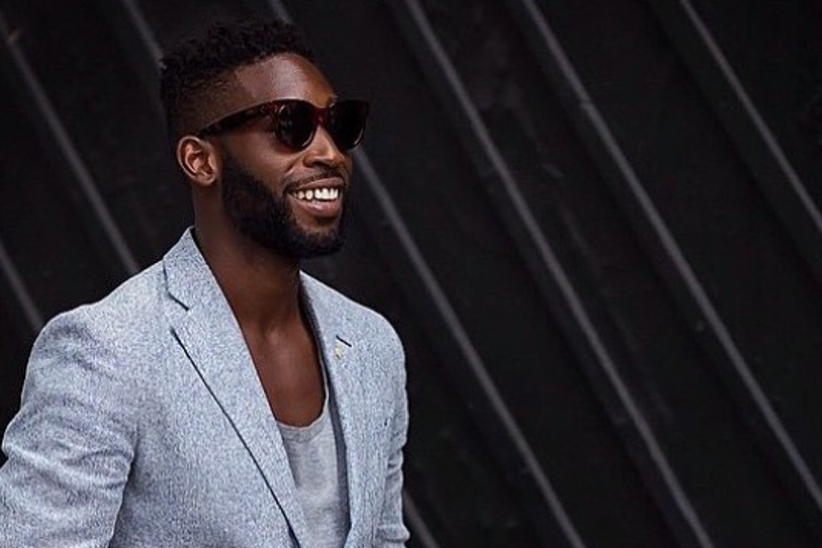 a man in a grey wool suit & shades