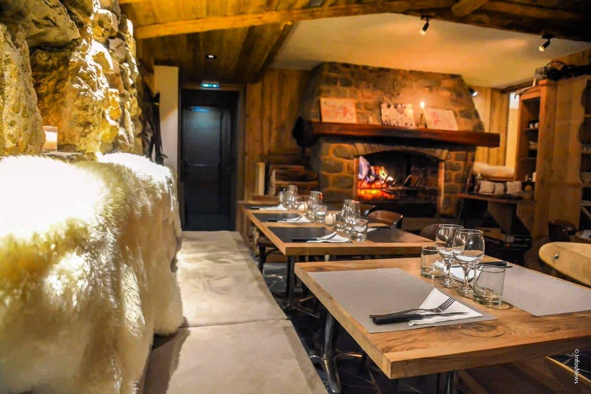 A photo of a restaurant with a fireplace in the background