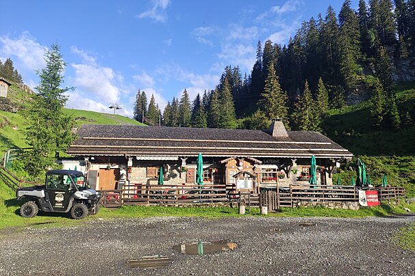 An atv is parked in front of a building with a sign that says coca cola