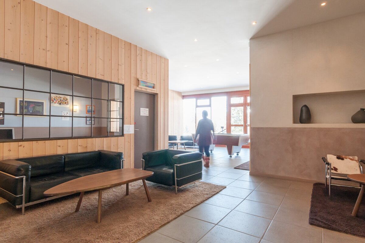 A room with a couch a chair and a table