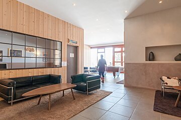 A room with a couch a chair and a table