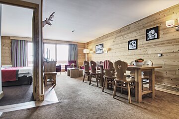 A living room with a dining table and chairs