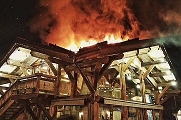 a chalet style restaurant on fire