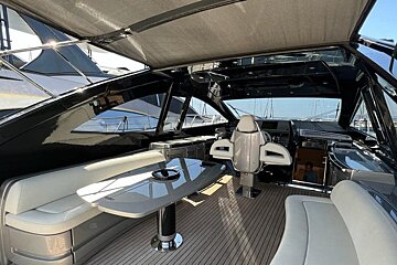 The inside of a boat with a table and chairs