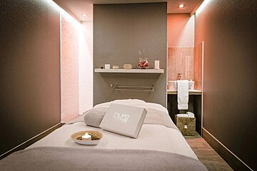A pure attitude box sits on a massage table