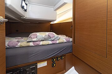 A bedroom with a bed and a box that says batteries on it
