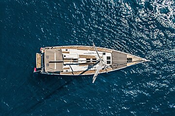 An aerial view of a sailboat in the ocean
