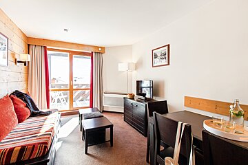 A living room with a couch a table and a television