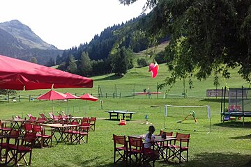 A lawn with tables and chairs and a sign that says le sport