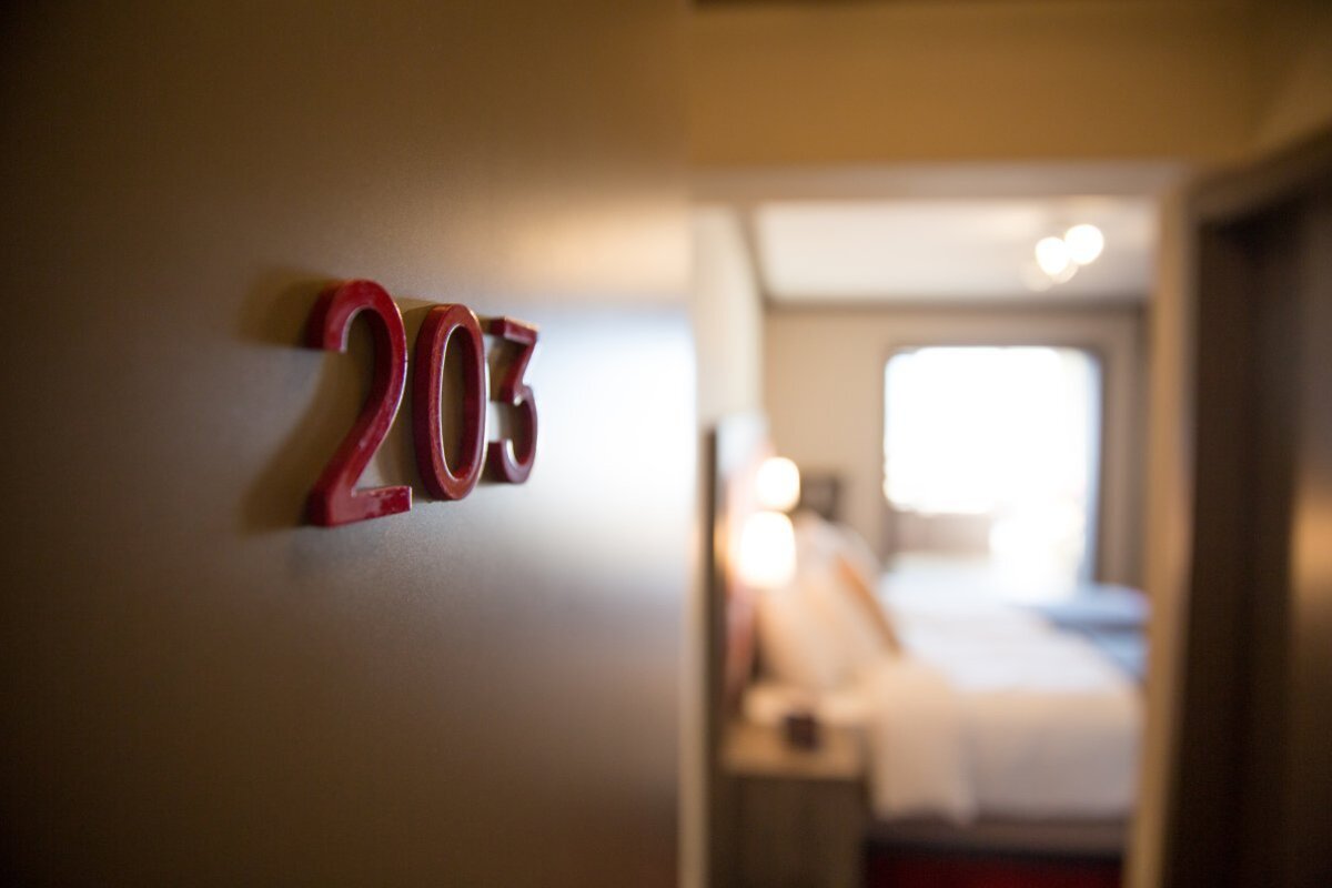A hotel room with the number 203 on the wall