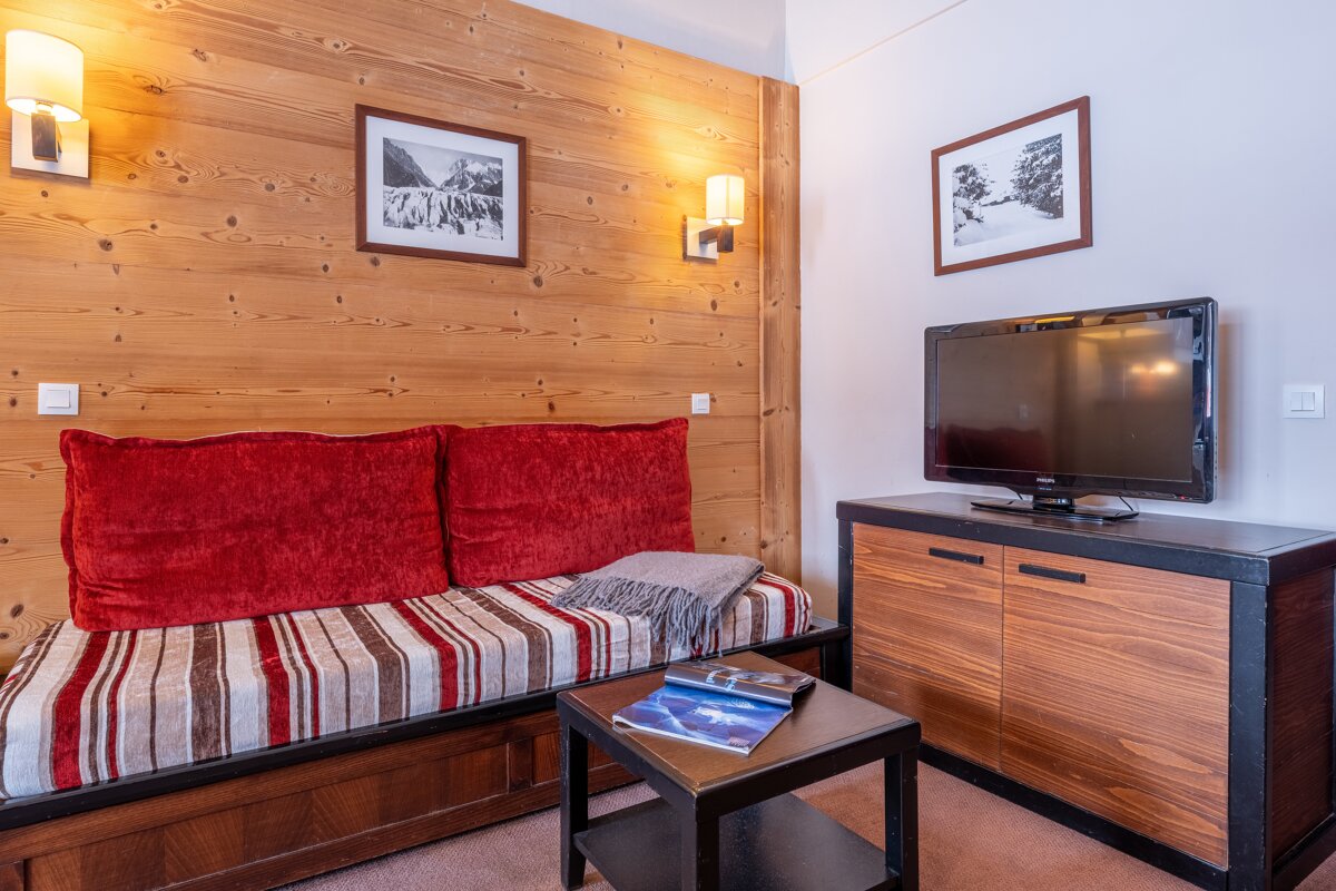 A living room with a couch and a flat screen tv